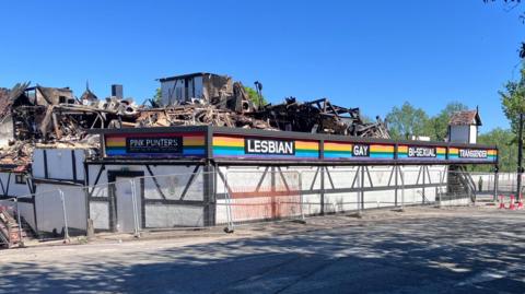 Rubble remains on the second floor of Pink Punters club which is surrounded by a steel fence.