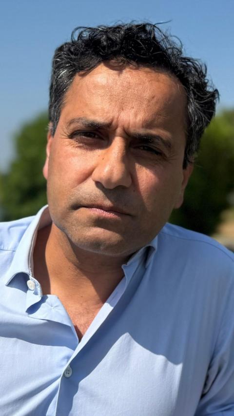 Former MP Rehman Chishti outdoors wearing a blue shirt