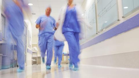 Blurred image of medical staff running through the hospital corridors. (stock photo)