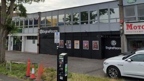 A Google Street View of the outside of a nightclub based on a business estate. Its black frontage is shuttered and closed.