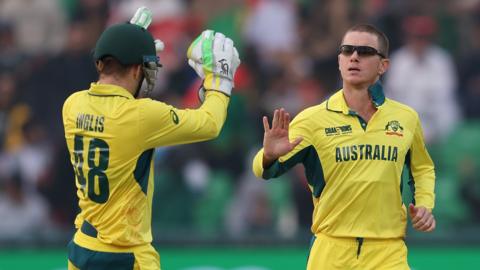 Australia spinner Adam Zampa (right) celebrates taking a wicket