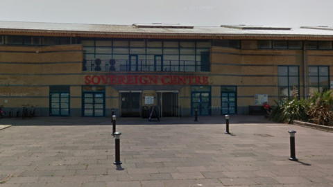 The entrance to the Sovereign Centre in Eastbourne - a cream building with Sovereign Centre 