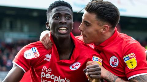 Panutche Camara (left) celebrates a goal for Crawley