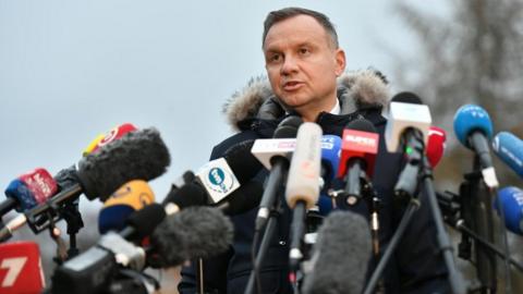 Polish President Andrzej Duda addresses the press during his visit to the village of Przewodow