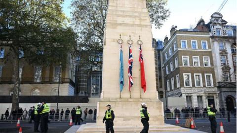 Police officers stand guard at the Cenotaph in Whitehall ahead of expected demonstrations in London