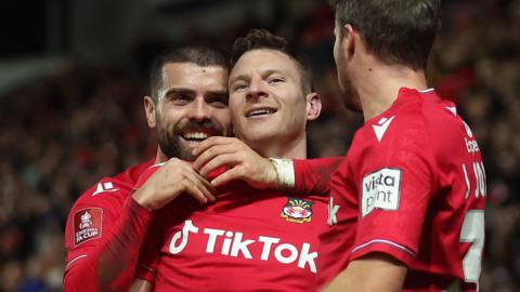 Wrexham's Elliot Lee, Paul Mullin and James Jones celebtrate a goal