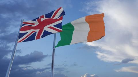 A British and Irish flag flying beside eachother