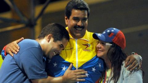 President Nicolas Maduro embraces his wife Cilia Flores and son Nicolas Maduro during a 2013 campaign rally