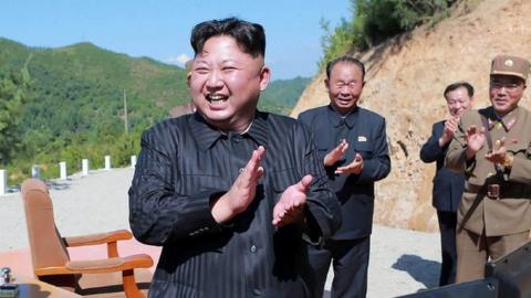 This picture taken on 4 July, 2017 shows North Korean leader Kim Jong-Un celebrating the successful test-fire of an intercontinental ballistic missile