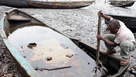 Fishing canoes on polluted creek