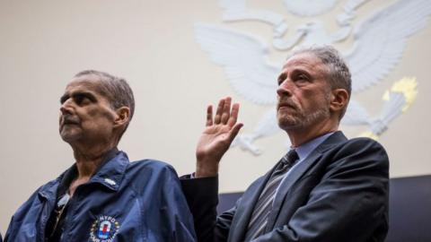 Retired New York Police Department detective and 9/11 responder Luis Alvarez, left, and Former Daily Show Host Jon Stewart, right are sworn in before testifying during a House Judiciary Committee hearing on reauthorization of the September 11th Victim Compensation Fund on Capitol Hill on June 11, 2019 in Washington, DC