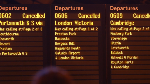 A train departure board at Brighton Station showing cancellations and disruption