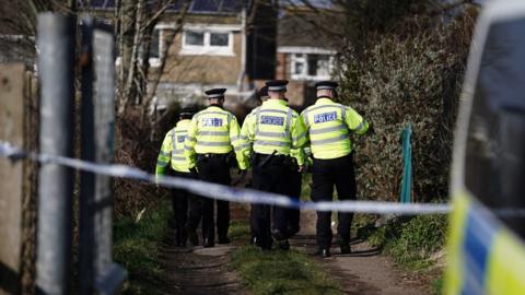 Police officers at a set of allotments in Brighton on Thursday