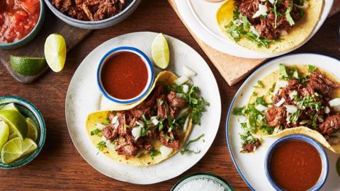 Three plates of birria tacos.