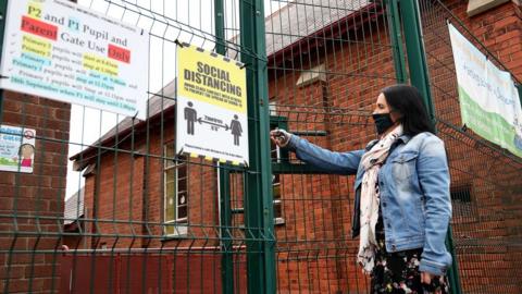 Harding Memorial Primary School’s Vice Principal Judith Baird locks up the school as primary and secondary schools across the province close for 2 weeks as part of new Covid restrictions.