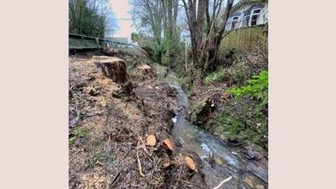 A picture of the A40 landslip site showing rocks and debris in the water