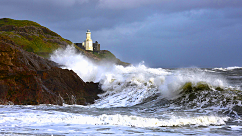Big waves lash rocks near Mumbles Lighthouse