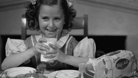 Girl from the 1950s drinking milk.