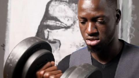Artist Boubou with a dumbell