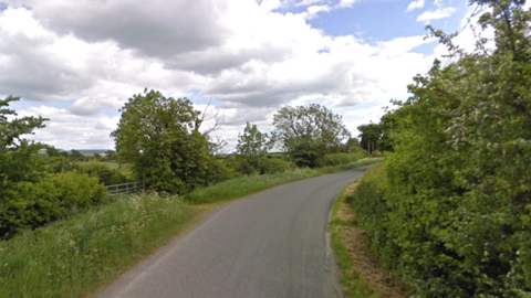 A general view down Coate Road in Devizes showing greenery and trees