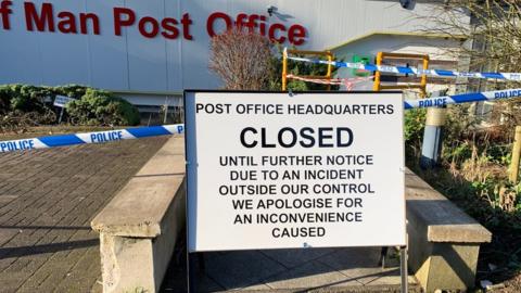 Sign outside post office building stating it is closed