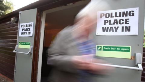 A voter leaves Broomhouse Community Hall polling station in Glasgow after casting their vote for the local council elections.