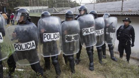 Police stand guard after a successful operation to rescue four hostages during a prison riot at the Centro Correccional Etapa II reformatory in San Jose Pinula, Guatemala