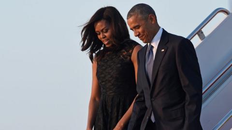 Barack and Michelle Obama walk down the steps of Air Force One