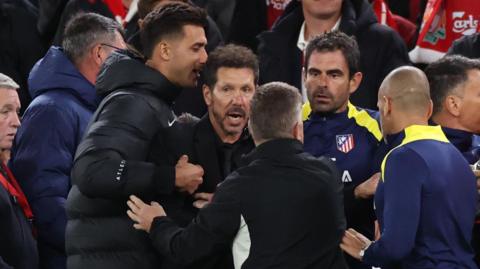 Diego Simeone is held back before being sent off in his side's defeat at Liverpool