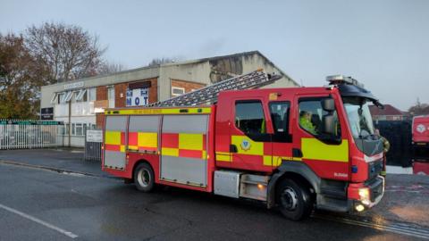 Fire engine outside MOT tyre centre following fire