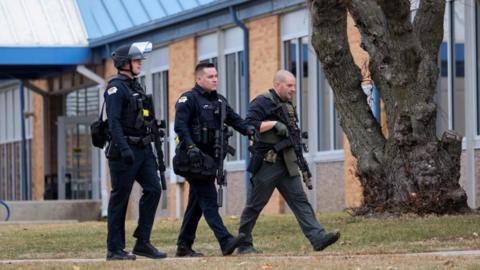 Armed police at the scene of a shooting at Perry High School in Perry, Iowa