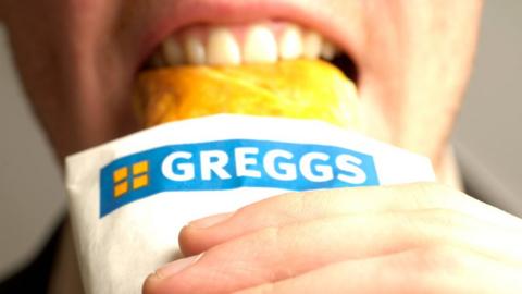 Man eats Greggs sausage roll