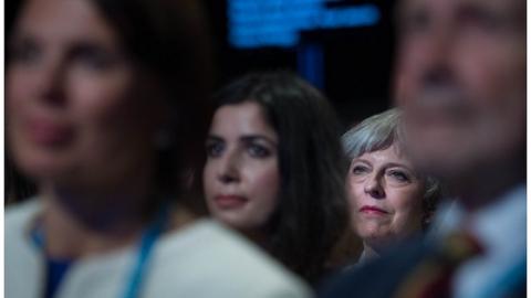 Theresa May listening to a speech at the Conservative Party conference