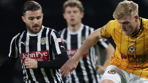 Will Evans of Newport County (R) competes with Dan Crowley of Notts County