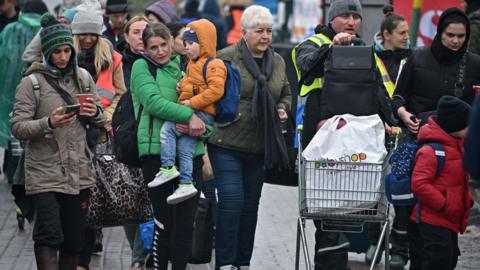 Refugees and volunteers are seen at Medyka border crossing as people pass through from war-torn Ukraine on April 01, 2022 in Medyka, Poland