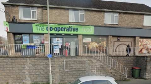 The outside of the Co-op store, with stairs leading down to the street below.