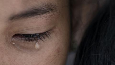 A relative of Leover Miranda, an alleged drug dealer who was killed on August 3, 2017, cries during Leover"s burial at the Manila North Cemetery on August 20, 2017