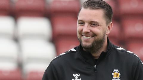 Cambridge boss Mark Bonner is all smiles on the pitch