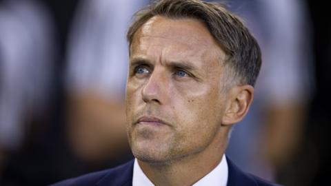 Phil Neville coaches on the sideline during an MLS match