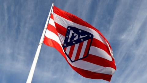 Atletico Madrid badge on a flag