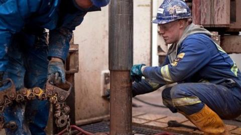 Fracking workers looking at drill