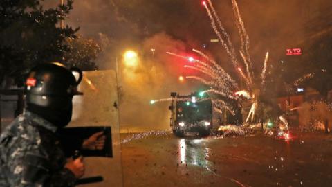 Young Shia men throw fireworks at security forces in Beirut, Lebanon (17 December 2019)