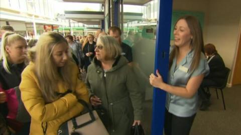 Thomas Cook staff welcoming customers into a pop-up shop