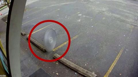 Saw blade flying through car park with red ring around it