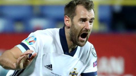 Niall McGinn celebrates after netting the second-half equaliser in Sarevejo