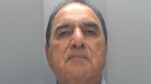 Muhammad Iqbal, a man in his 60s with thin, black hair.