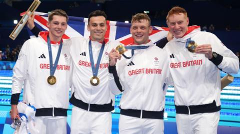 Great Britain's Duncan Scott, James Guy, Matthew Richards and Tom Dean pose with their gold medals