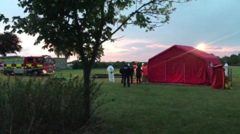 A red tent set up by emergency services at the scene of an aircraft crash in Worcestershire