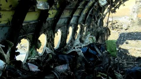 Burnt-out cabin of plane, 6 May 19