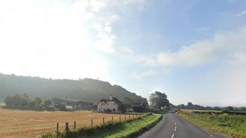 A rural road with fields either side